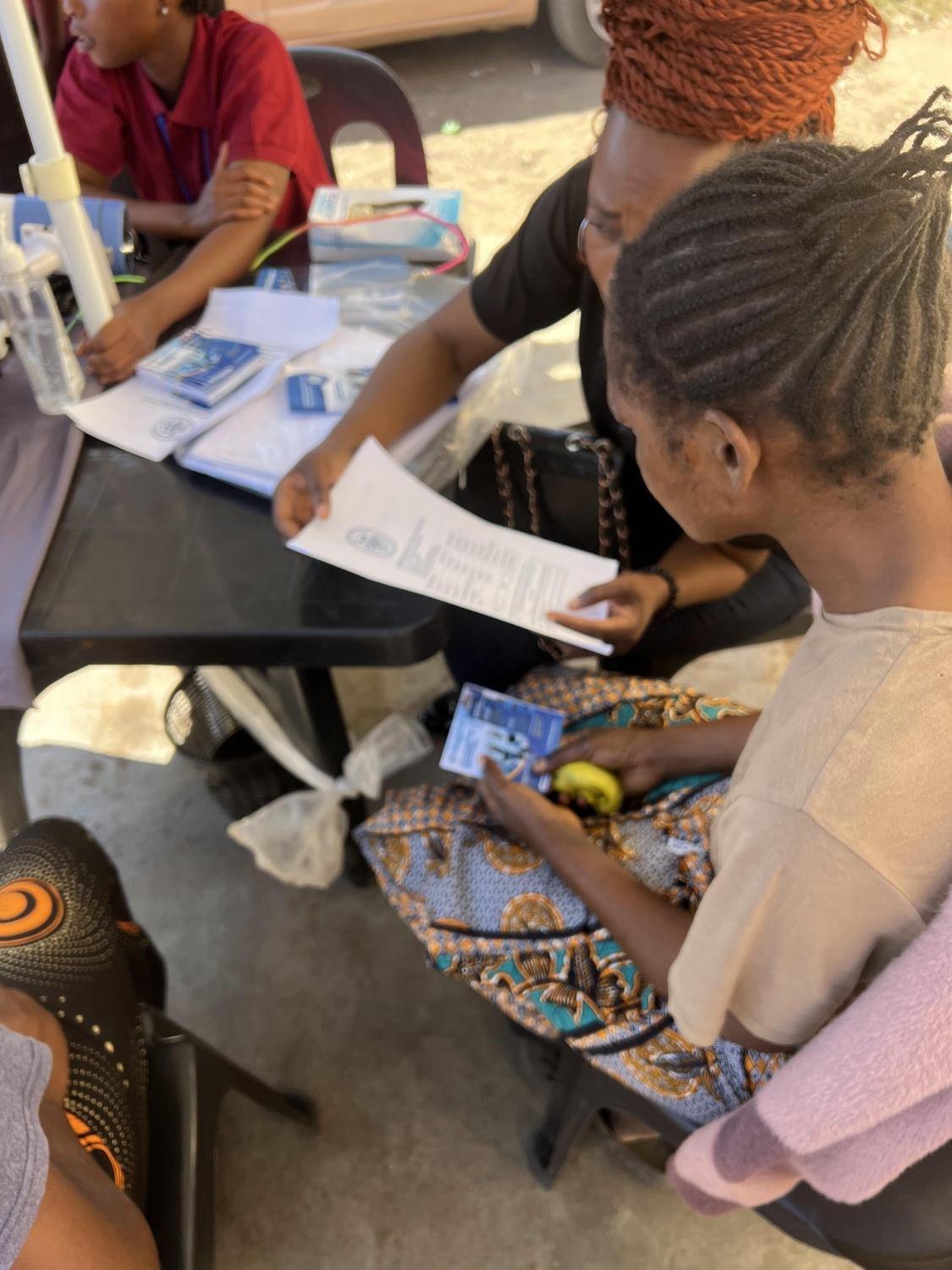 Fernwood outreach table with staff registering a community member